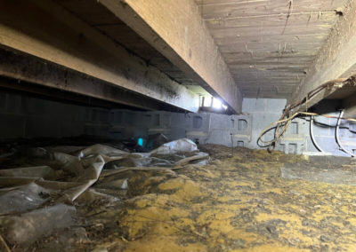 Before photo showing crawlspace cluttered with debris in Mike Gibbens' home in Fayetteville, NC