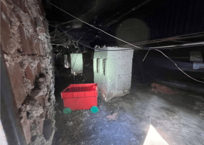 Crawlspace with debris and old insulation in West End, NC