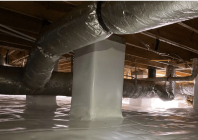 Crawlspace with new encapsulation installed, featuring clean vapor barriers on the floor and pillars and a dehumidifier system.