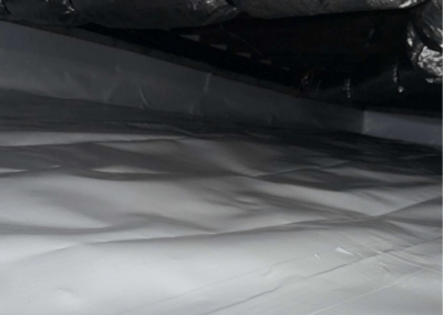 Encapsulated crawl space with a vapor barrier and insulated ducts to improve moisture control and energy efficiency.