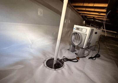 Crawl space equipped with a sump pump and dehumidifier system for advanced water and humidity control.