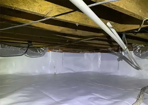After – Sealed crawl space with white vapor barrier