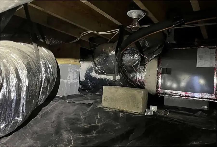 Before Crawl-space with HVAC unit and exposed block piers