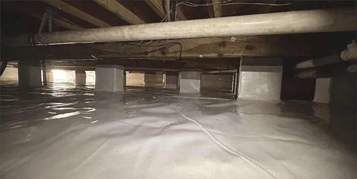 Professional crawl space encapsulation with white liner and insulated supports