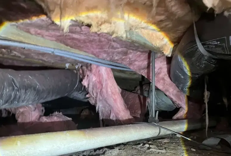 Damaged Crawl Space Insulation and Exposed Ductwork